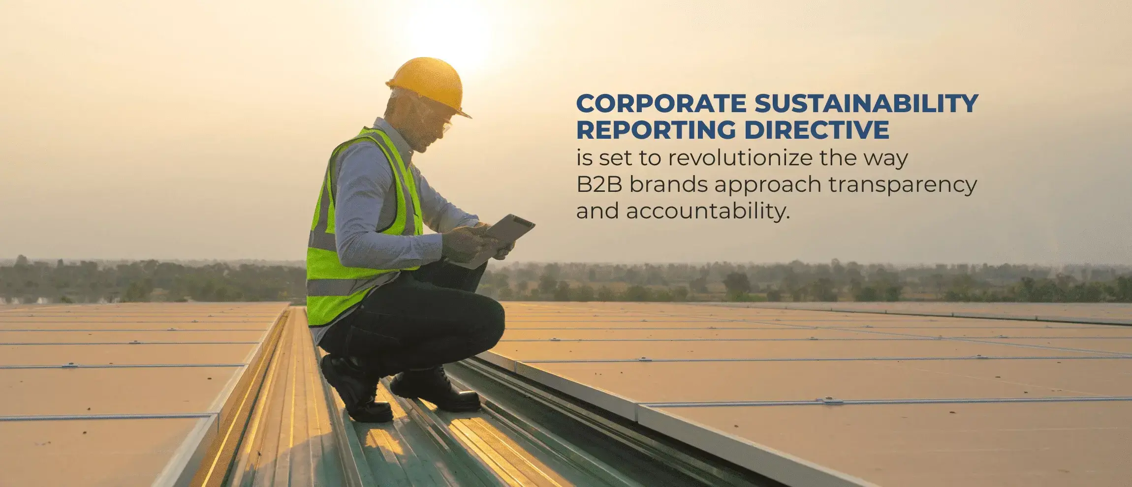 Worker in a hard hat and safety vest uses a tablet on a solar-panel roof beside text about the Corporate Sustainability Reporting Directive.